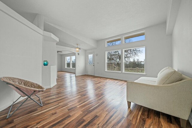 living area featuring dark wood-style floors and baseboards