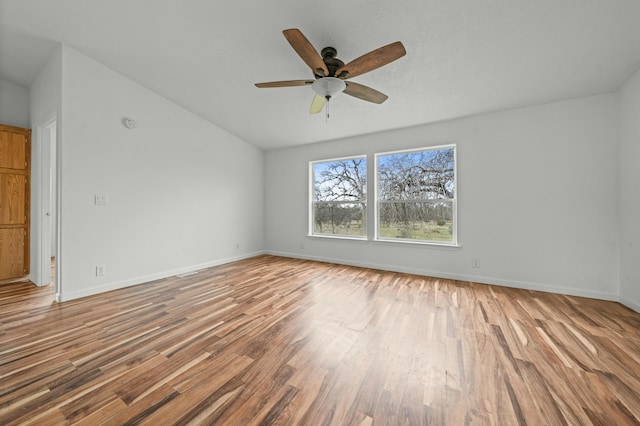 empty room with a ceiling fan, baseboards, and wood finished floors