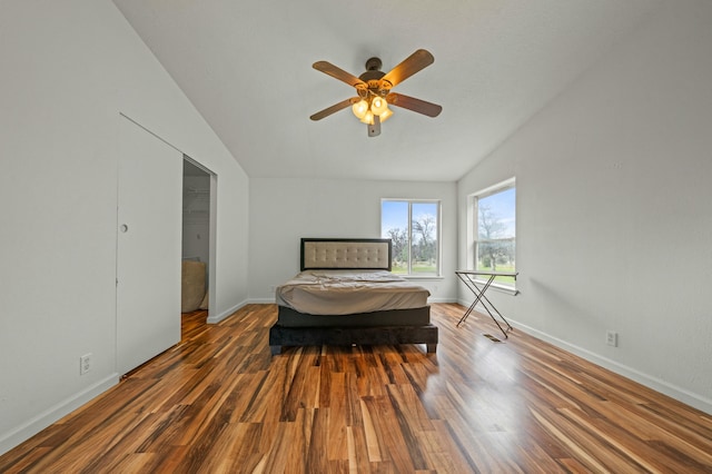 bedroom featuring a ceiling fan, baseboards, and wood finished floors