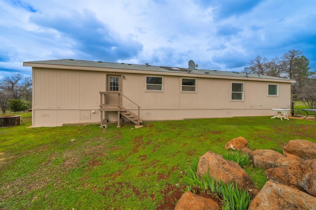 back of house featuring crawl space and a yard