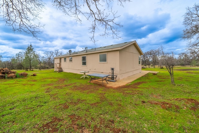 rear view of property featuring crawl space and a lawn