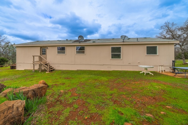 rear view of property with a yard