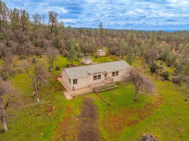 birds eye view of property featuring a view of trees