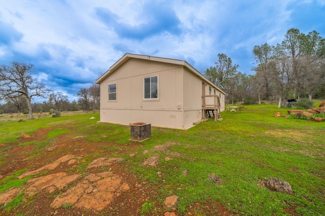 view of home's exterior featuring crawl space and a lawn