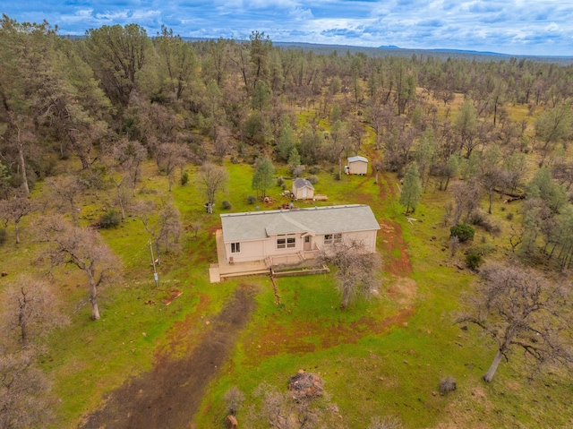 drone / aerial view with a wooded view