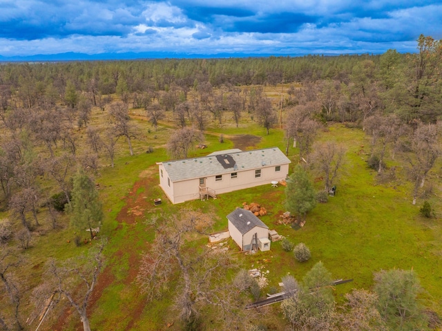 birds eye view of property featuring a view of trees