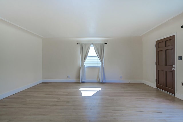 unfurnished room with baseboards, light wood-style floors, and ornamental molding