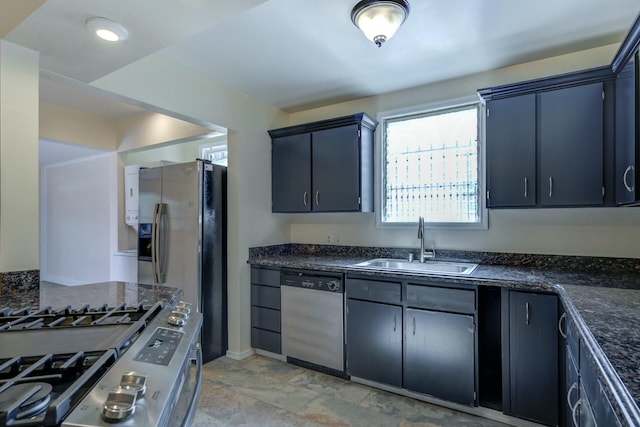 kitchen with a sink, baseboards, and appliances with stainless steel finishes