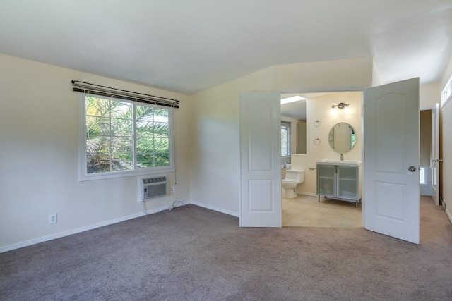 unfurnished bedroom with multiple windows, light carpet, lofted ceiling, and a wall mounted AC