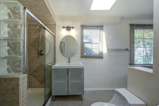 full bath featuring vanity, toilet, a skylight, and a shower stall