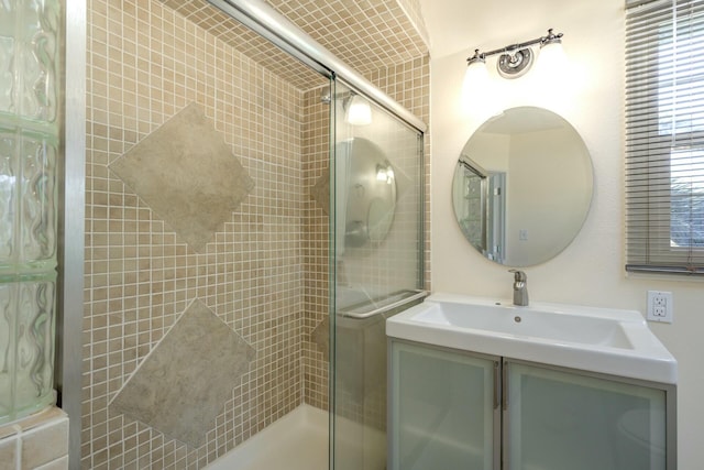 full bath featuring a stall shower and vanity