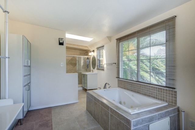 bathroom featuring plenty of natural light, a stall shower, and a whirlpool tub