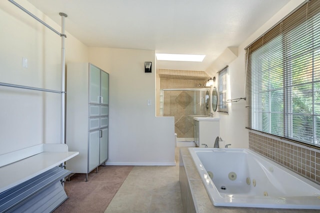 bathroom featuring a shower stall, vanity, baseboards, and a whirlpool tub