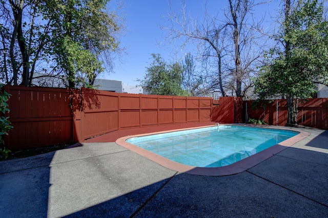 view of swimming pool featuring a patio area, a fenced in pool, and a fenced backyard