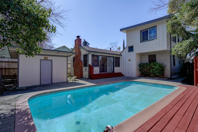 view of pool featuring a fenced in pool, an outbuilding, a storage shed, and fence