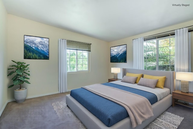 carpeted bedroom with vaulted ceiling and baseboards