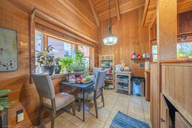 dining space with wooden ceiling, wood walls, vaulted ceiling, and light tile patterned flooring