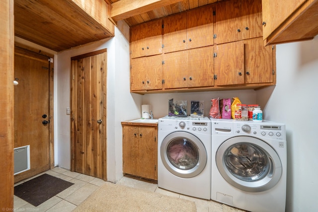 washroom featuring wooden ceiling, light tile patterned flooring, a sink, independent washer and dryer, and cabinet space