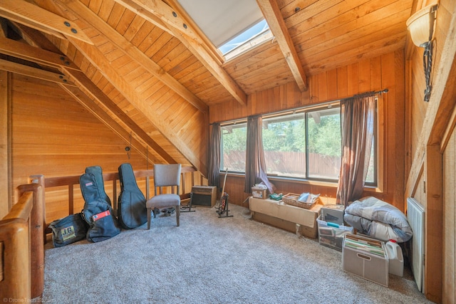 interior space featuring wood ceiling, carpet, vaulted ceiling with skylight, and wooden walls