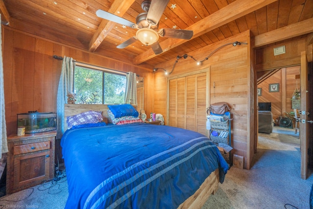 bedroom with carpet, a closet, wooden walls, wooden ceiling, and beamed ceiling