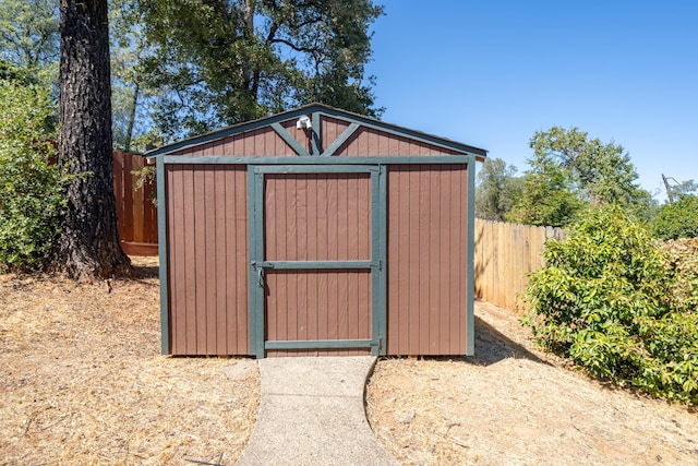 view of shed featuring fence