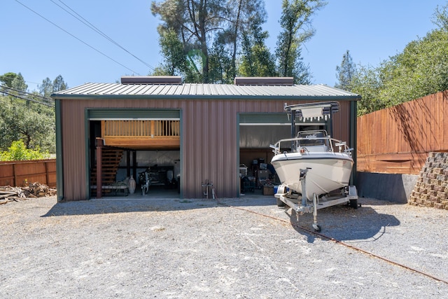 detached garage featuring fence