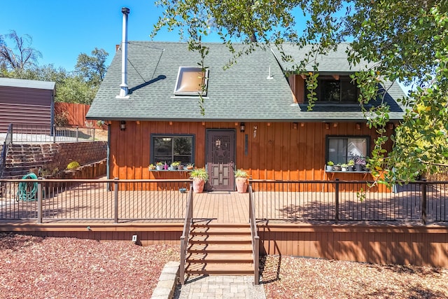 chalet / cabin with fence and roof with shingles