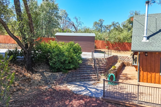 view of yard featuring fence and an outdoor structure