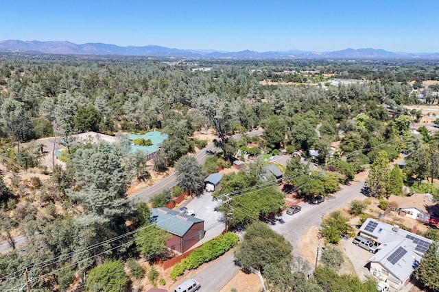 drone / aerial view featuring a mountain view and a wooded view