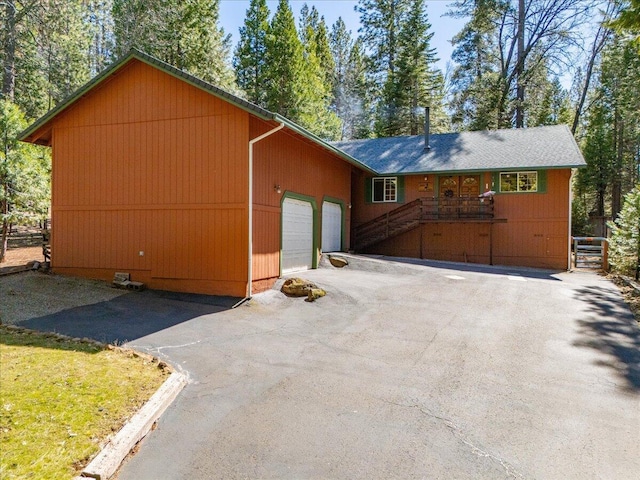 exterior space featuring driveway, a garage, and crawl space