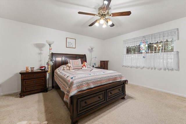 bedroom featuring a ceiling fan, baseboards, and light colored carpet