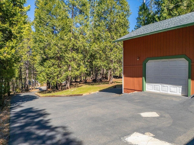 garage with aphalt driveway