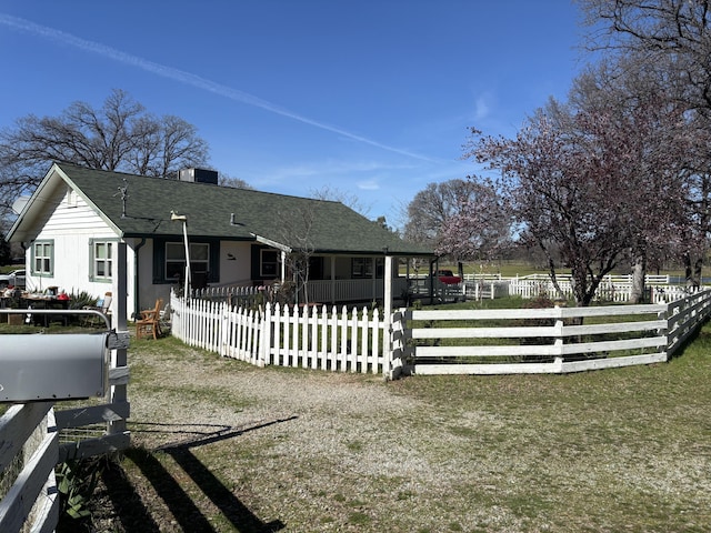 view of front of house with a fenced front yard, roof with shingles, central AC, and a chimney