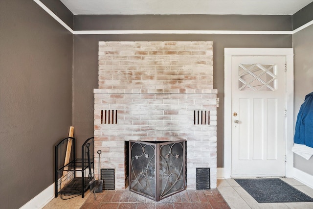 property entrance with a brick fireplace and visible vents