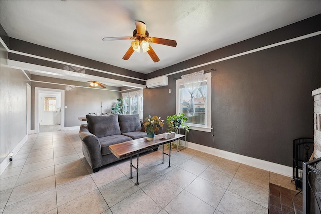 tiled living area with ceiling fan, baseboards, and a wall mounted AC