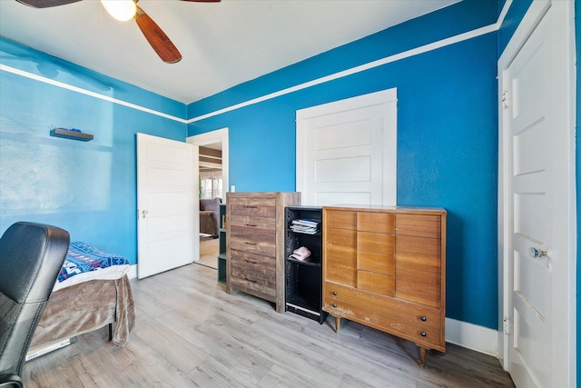 office space with ceiling fan, baseboards, and wood finished floors