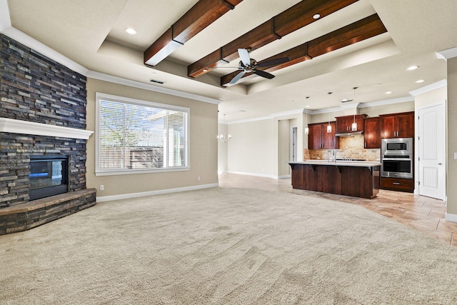 unfurnished living room with a stone fireplace, a raised ceiling, light colored carpet, and baseboards