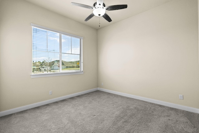 unfurnished room with baseboards, carpet floors, and a ceiling fan