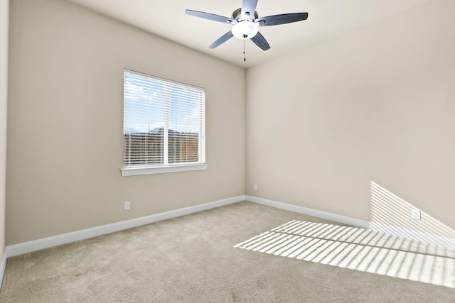 spare room with baseboards, carpet floors, and ceiling fan