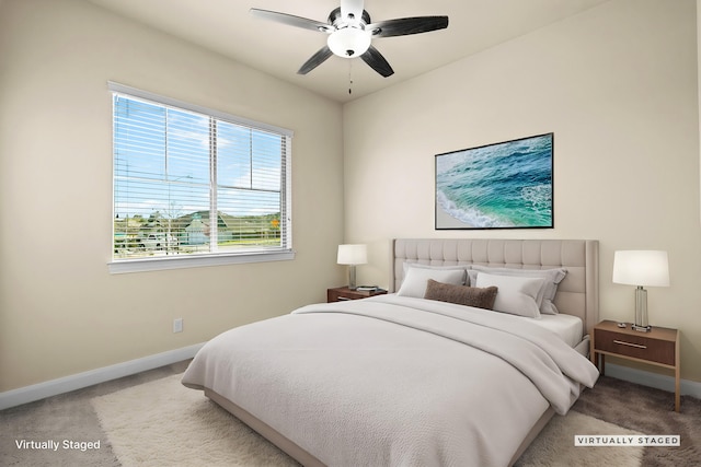 carpeted bedroom featuring a ceiling fan and baseboards