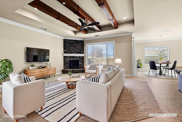 tiled living area featuring crown molding, a fireplace, baseboards, and a wealth of natural light