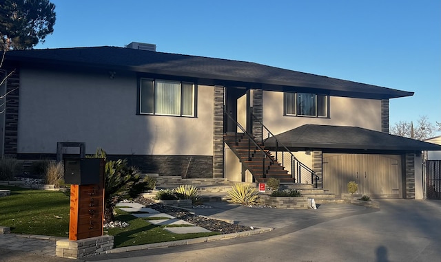 view of front of home with stone siding, stucco siding, stairway, and a garage