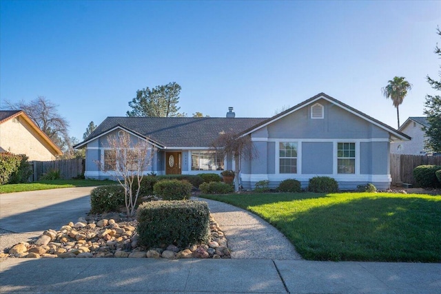 ranch-style house with a front yard, fence, driveway, and a chimney