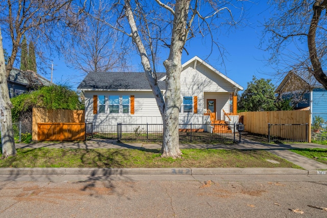 bungalow-style home featuring a fenced front yard