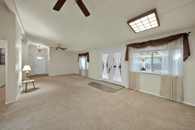 interior space featuring light colored carpet, french doors, baseboards, and ceiling fan