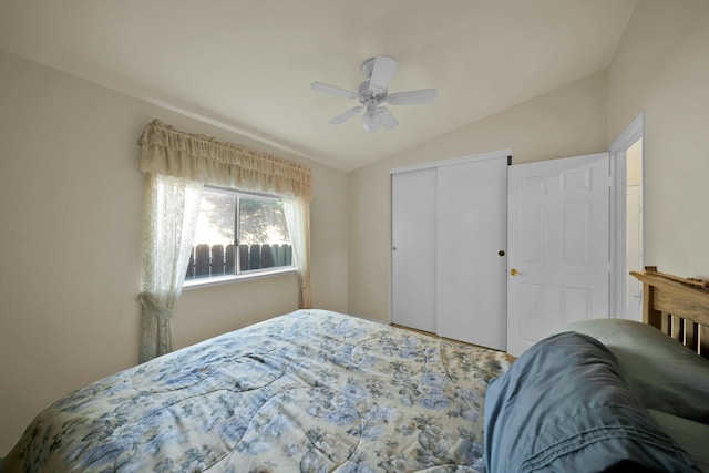 bedroom featuring a closet, ceiling fan, and lofted ceiling