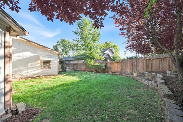 view of yard with a fenced backyard