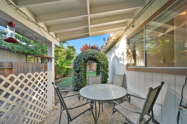 view of patio with outdoor dining area and fence