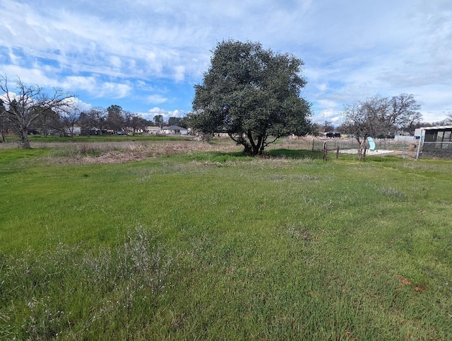 view of yard featuring a rural view and fence