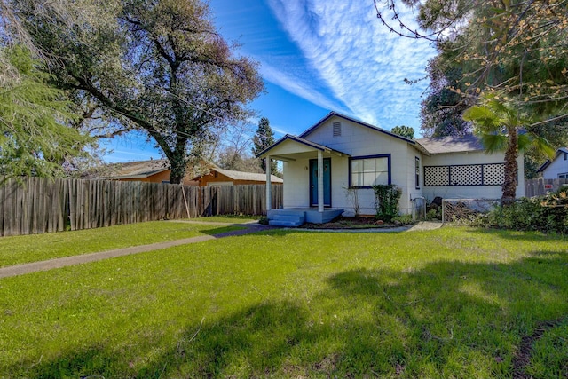 exterior space featuring a front yard and fence